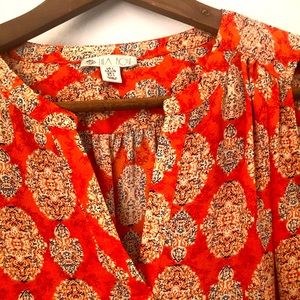 Orange sleeveless print top